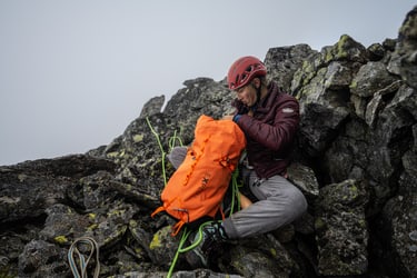 opening backpack  during a climbing rest