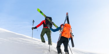 in use image Couloir dark lava and black backview with skis tied on the side
